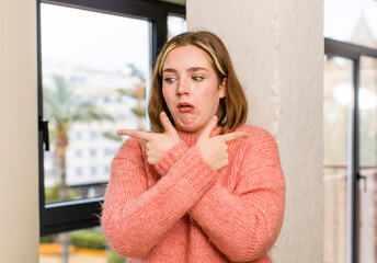 pretty caucasian woman looking puzzled and confused, insecure and pointing in opposite directions with doubts. home interior concept