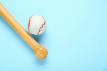 Wooden baseball bat and ball on light blue background, flat lay. Space for text
