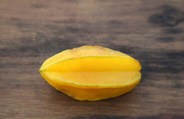 One delicious ripe carambola on wooden table
