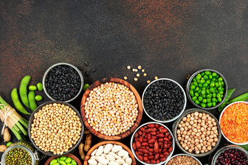 Legumes, beans and sprouts. Dried, raw and fresh, top view. Red kidney beans, lentils, mung beans, chickpeas, soybeans, edamame, green peas, Healthy, nutritious, diet food, vegan protein
