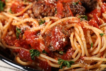Delicious pasta with meatballs and tomato sauce as background, closeup