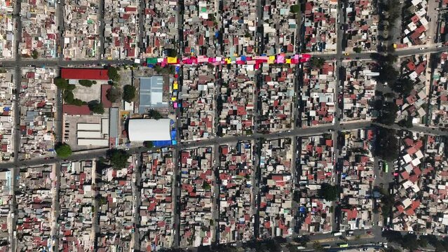 Aerial view above a ghetto, in sunny Iztapalapa, Mexico - top down, drone shot