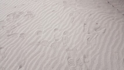 white sand pattern texture, fine sand, summer beach sand dune background, footprints on sand