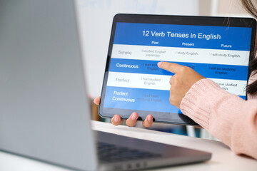 Close up of english teacher holding digital tablet while teaching english language online class