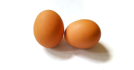 Two chicken eggs isolated on a white background