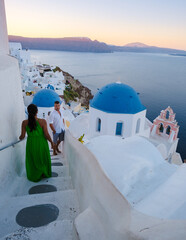 couple of men and women on vacation in Santorini Greece. young couple on vacation in Greece Santorini - obrazy, fototapety, plakaty