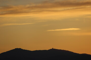 red sunset sky in the clouds, golden hour abstract clouds , orange color horizon, orange sky with mountain silhouette