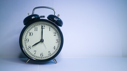 Background photo of an alarm clock showing 8:00	