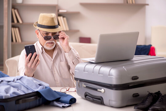 Old Man Preparing For Trip At Home