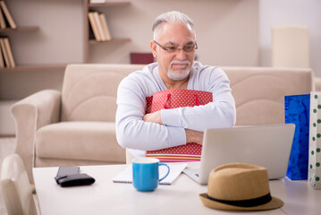 Old man with many bags in Christmas concept at home