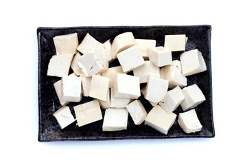 White tofu in black plate on white background