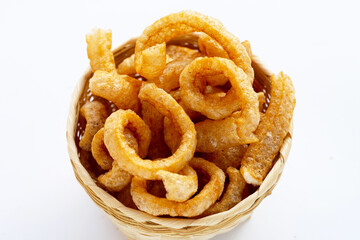 Fried crispy pork rinds on white background.