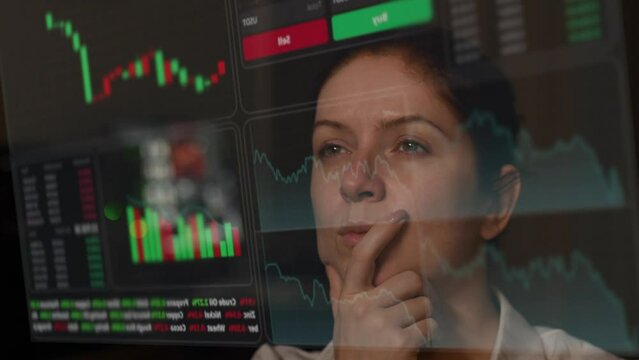 Caucasian woman carefully looks at the hud menu. Stock charts. brokerage terminal.