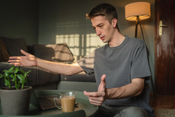 A young guy is using his laptop to study or do business from home