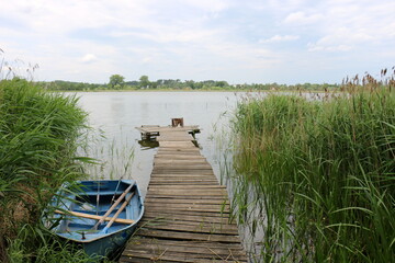Naklejka premium Rowing boat on the shore of Lake Naroch.