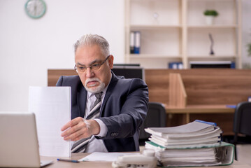 Old male boss employee working in the office