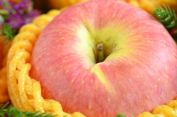 close up pink apple in yellow wrap bubble, healthy food