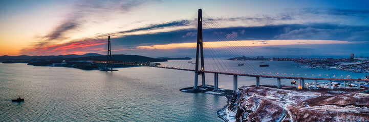 Winter panoramic view of sunset over famous cable-stayed bridge from Vladivostok to Russky Island,...