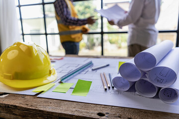 Civil engineer team meeting with helmet and typing in house design on construction site, foreman, project manager, industry engineer team work Architect, foreman, professional team