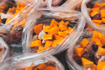 Process of preparing bowls with natural raw pet dog food at home, preparation of healthy raw barf for cats dogs, with duck, turkey, offals, meat, vegetables, assorted fresh portions in containers bags