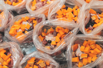 Process of preparing bowls with natural raw pet dog food at home, preparation of healthy raw barf for cats dogs, with duck, turkey, offals, meat, vegetables, assorted fresh portions in containers bags