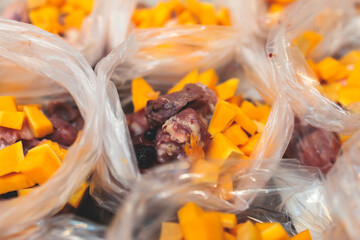 Process of preparing bowls with natural raw pet dog food at home, preparation of healthy raw barf for cats dogs, with duck, turkey, offals, meat, vegetables, assorted fresh portions in containers bags