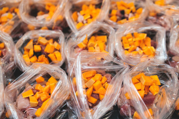 Process of preparing bowls with natural raw pet dog food at home, preparation of healthy raw barf for cats dogs, with duck, turkey, offals, meat, vegetables, assorted fresh portions in containers bags