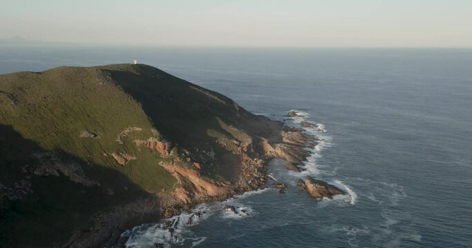 South Africa Robberg Nature Reserve Green Headland with Rock and Ocean Waves crashing below
