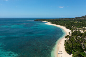 Fototapeta na wymiar Seascape with tropical sandy beach and blue ocean. Pagudpud, Ilocos Norte Philippines