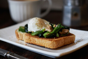 homemade healthy open sandwich: toast topped with spinach, tuna, avocado and poached egg