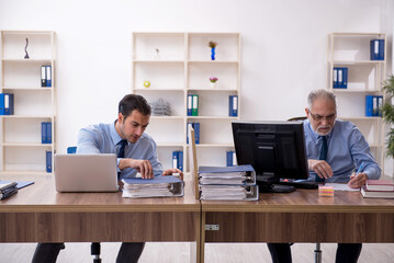 Two male colleagues working in the office