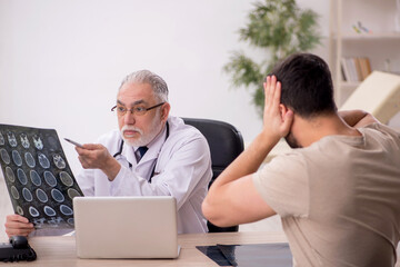 Young male patient visiting old male doctor radiologist