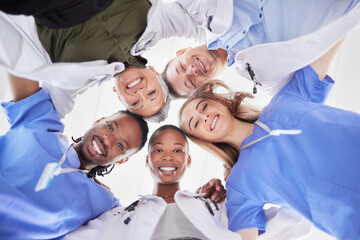 Happy teamwork, diversity and doctors in huddle of support, help or medical collaboration. Portrait group of healthcare workers in circle with heads together, smile face and happy hospital management