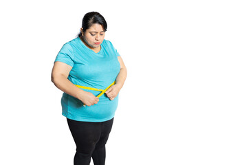 Unhappy fat indian woman check belly with measuring tape isolated over white background. Full...