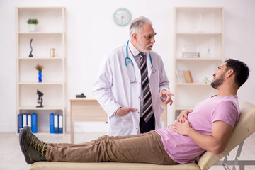 Young male patient visiting old male doctor