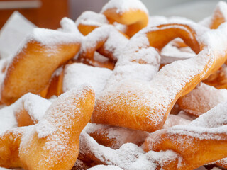 Close-up of fresh homemade cakes sprinkled with white powdered sugar that looks like snow....