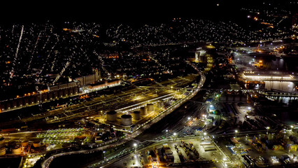 Novorossiysk, Russia. Port of Novorossiysk at night. Night city lights. Tsemesskaya Bay in the Black Sea, Aerial View