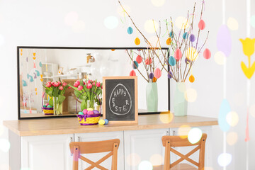 Beautiful Easter decorations on table in light kitchen