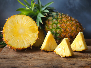 Fototapeta na wymiar Ripe pineapple fruit cut in half and triangle shape.