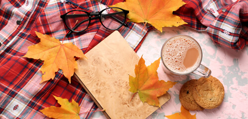 Composition with cup of aromatic coffee, warm shirt, book and autumn leaves on color background,...