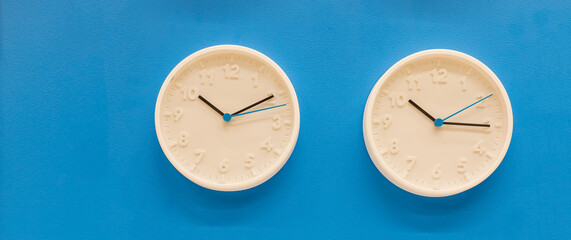 White big analogue plain wall clock on trendy pastel blue background. copy space, time management...