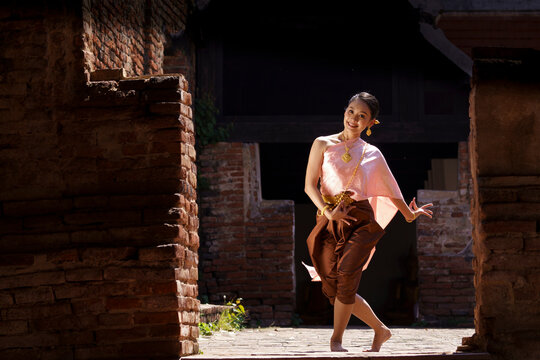 A beautiful lady  in Thai traditional costume shows traditional basic Thai dance.