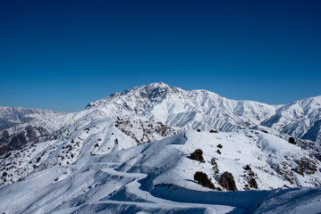 Mountains resort Amirsoy. Sun and fog landscape of Western Tien Shan. Ski tourism of Uzbekistan.