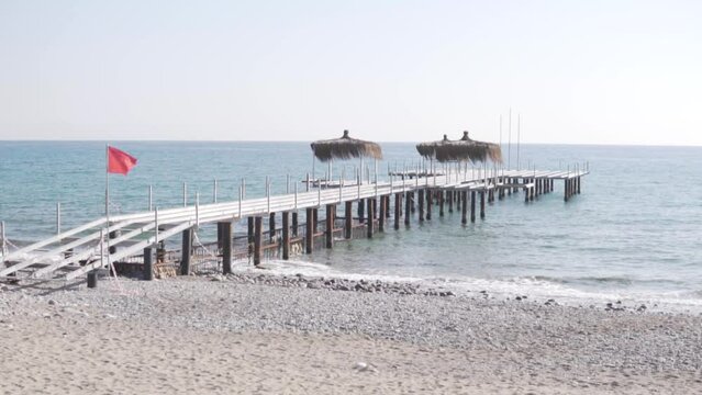 Close-up of the dismantled pier on the beach at the hotel in Turkey in winter