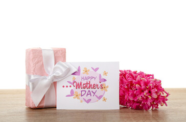 Greeting card with text HAPPY MOTHER'S DAY, hyacinth flower and gift on table against white background