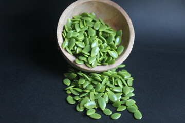 lots of lamtoro seeds on a black background