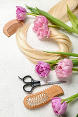 Hairdresser's tools with tulips on white background. Hello spring