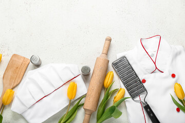 Chef's uniform with utensils and tulips on white background. Hello spring