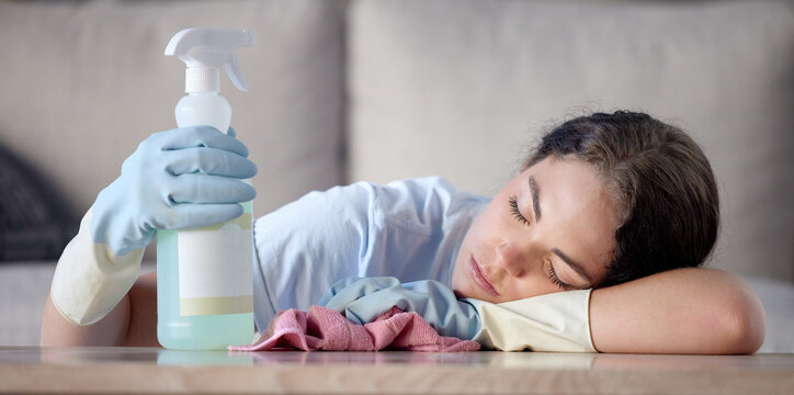 Tired Woman, Housekeeping And Sleeping On Table With Detergent Bottle By The Living Room Sofa At Home. Female Exhausted From Spring Cleaning, Burnout Or Nap After Disinfection With Sanitizer Bottle