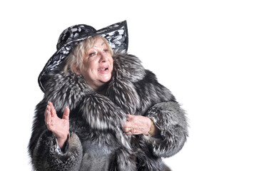 senior woman wearing black hat and fur coat